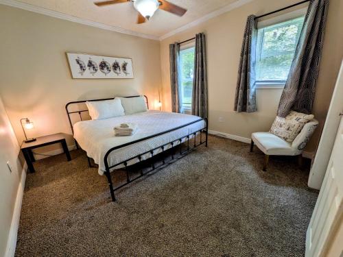 a bedroom with a bed and a chair and a window at Hook Wine and Sinker in Marion