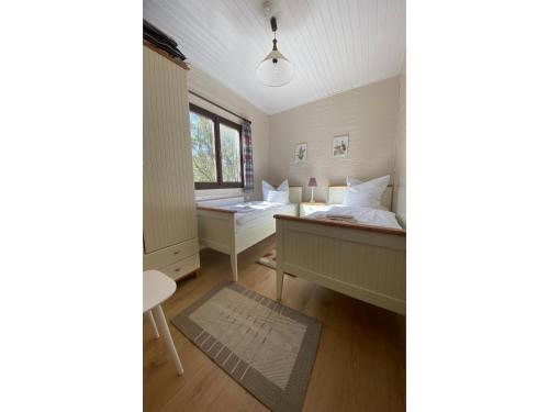 a room with two beds and a desk and a window at Rückzugsort mit Terrasse, Eschede in Eschede