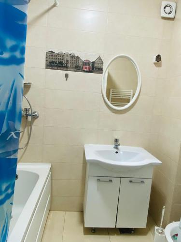 a bathroom with a sink and a mirror at Apartament Daniela in Năvodari