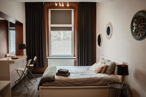 a bedroom with a bed and a window at Apartamenty Młyńska15 self check-in 24h in Katowice