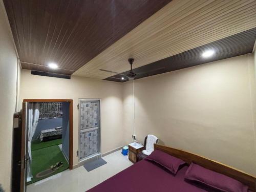 a room with a bed and a ceiling at RADHE RADHE HOMESTAy in Dithur