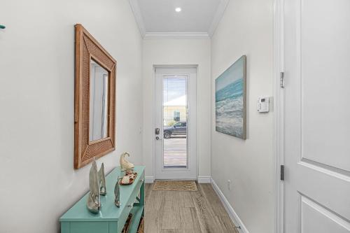 a hallway with a blue table and a mirror at Lavender Life in Saint James City