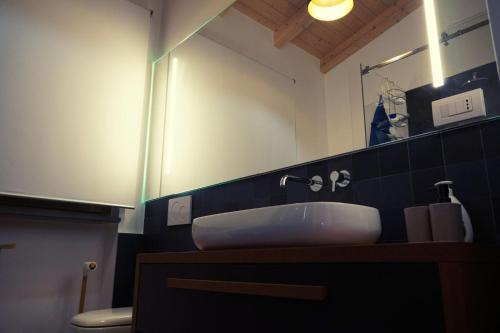 a bathroom with a sink and a mirror at Aurora Lucana in Matera