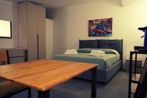 a bedroom with a bed and a wooden table at Aurora Lucana in Matera