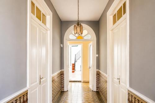 a hallway with a chandelier in a home at Casa Los Profesores, encanto tradicional canario en La Orotava in La Orotava