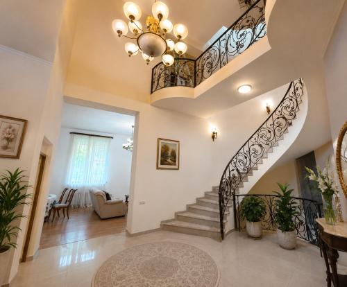 a staircase in a home with a chandelier at Dream House Hostel & Hotel in Yerevan
