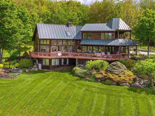 an aerial view of a large house with a yard at Valley View in Stowe