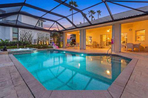 a swimming pool in the backyard of a house at Gorgeous home with private pool & outdoor space dock in Cape Coral
