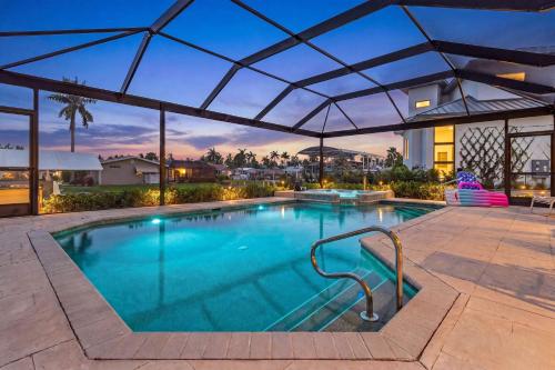 a large swimming pool with a canopy over it at Gorgeous home with private pool & outdoor space dock in Cape Coral