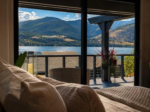 a bedroom with a view of a lake and mountains at Designer Lakefront Condo E3 Wapato Point Chelan in Manson