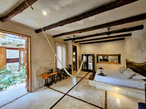 a bedroom with a bed and a desk in it at La Casa de Mia Holbox in Holbox Island