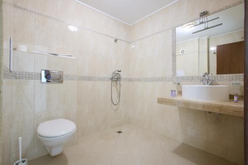 a bathroom with a toilet and a sink at La Piazza Primorsko Rooms & Apartments in Primorsko