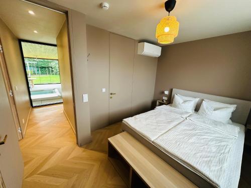 a bedroom with a large bed and a hallway at Het Huis - luxury villa near Tomorrowland in Willebroek