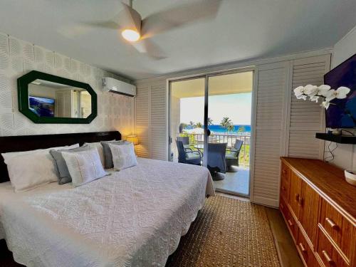 a bedroom with a bed and a view of the ocean at Puako Penthouse 409 - Top Floor Unit - Pool in Puako