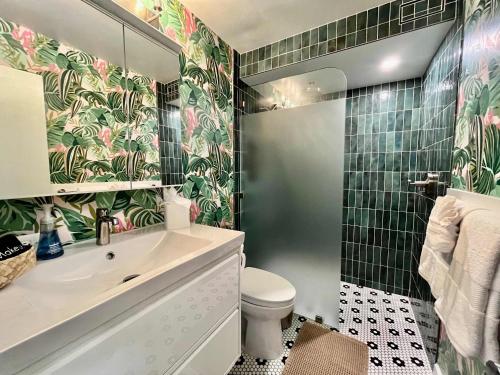 a bathroom with a sink and a toilet and a mirror at Puako Penthouse 409 - Top Floor Unit - Pool in Puako