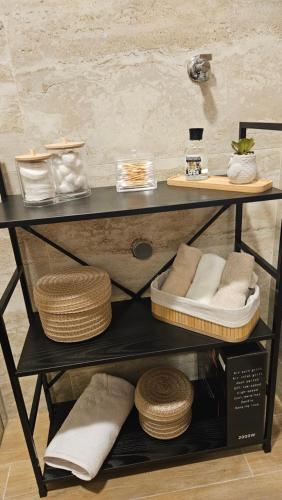 a shelf with towels and other items on it at Apartman E&A in Radanovići