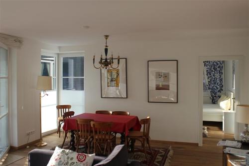 a dining room with a red table and chairs at Ferienresidenz Leogangerhof in Leogang