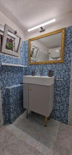 a bathroom with a sink and a mirror at Casa Marigé in San Nicola Arcella