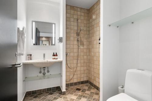 a bathroom with a sink and a shower at Trinity Hotel og Konference, BW Signature Collection in Fredericia