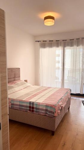 a bedroom with a large bed in front of a window at Apartment 22 - calm location in Bar