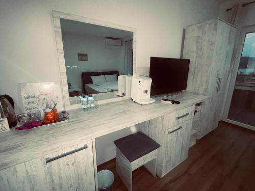 a room with a desk with a mirror at Mia Apartment in Veles