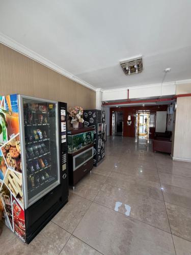 an empty room with a large refrigerator in a building at Korkmaz Rezidans in Kayseri