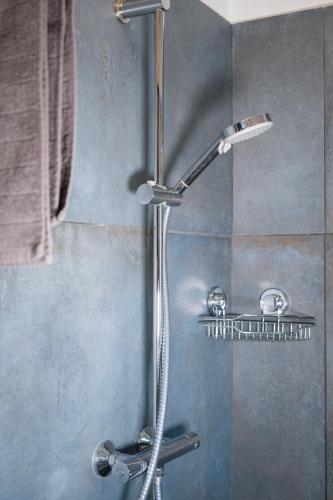 a shower with a shower head in a bathroom at Alpenloft Bregenz in Bregenz