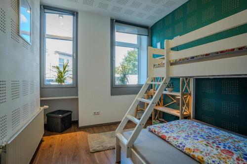 a bedroom with a bunk bed and a ladder at Alpenloft Bregenz in Bregenz