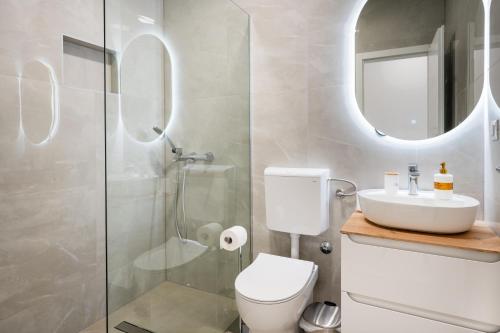 a bathroom with a shower and a toilet and a sink at Apartments Obradović in Neum