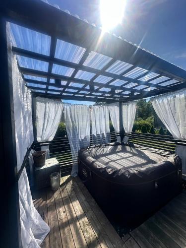 a bed under a pergola on a deck at Enebolig i Larkollen in Moss