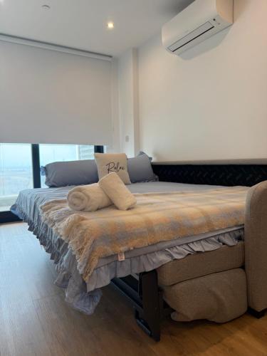 a bed in a room with a large window at New CP Victory suites studio sleeps 4 with pool and gym in Gibraltar