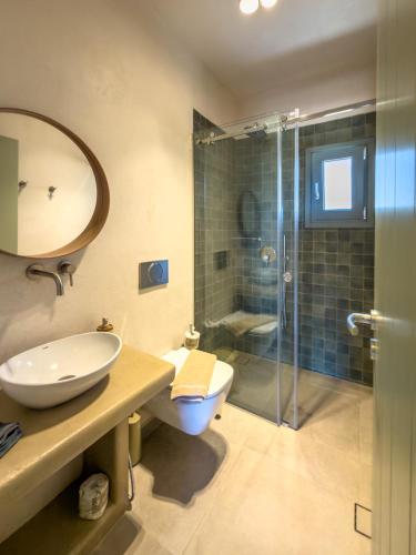 a bathroom with a sink and a toilet and a shower at Mikres Cyclades - Koufonisia House in Koufonisia