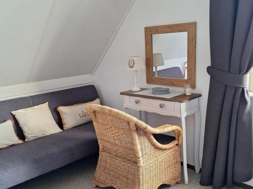 a living room with a couch and a mirror at Bungalow in Breskens near Beach & Lighthouse in Breskens