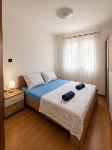 a bedroom with a bed with two pillows on it at Croatia Apartman Masa in Senj