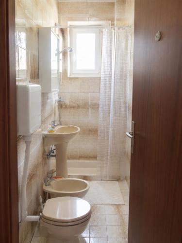 a bathroom with a toilet and a sink at Croatia Apartman Masa in Senj