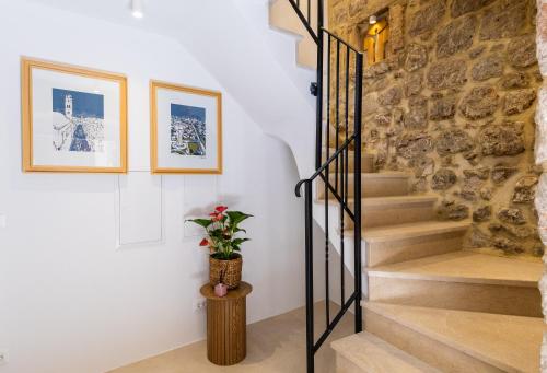 a staircase in a house with a stone wall at Villa Four Winds II in Dubrovnik