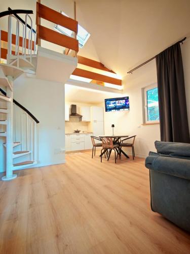 a living room with a table and a couch at Tiny Park House in Sabaudia