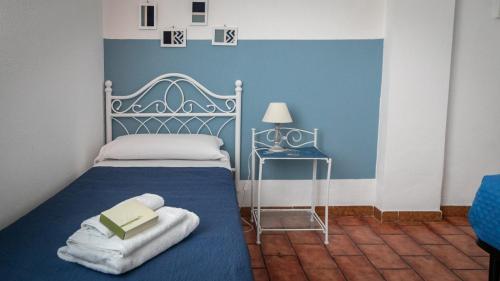 a bedroom with a bed with a book on it at Villa al Mare - Cala Gonone in Dorgali