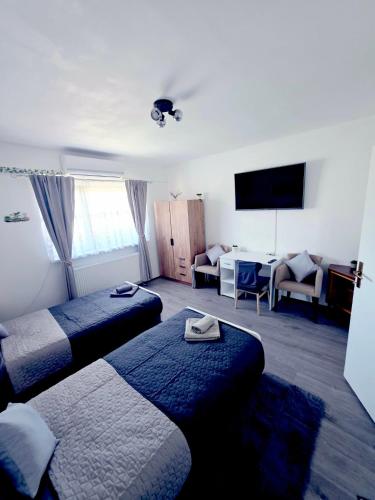 a hotel room with two beds and a television at Peđa in Ogulin