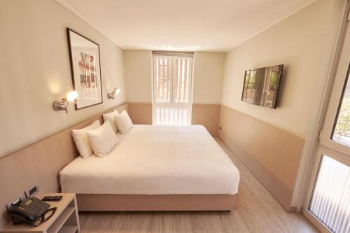 a bedroom with a bed with a phone on it at Novapark in Santiago