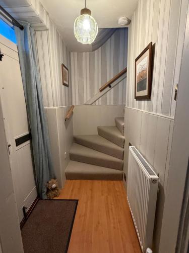 a staircase in a house with a stair case at Moulin Cottage in Pitlochry