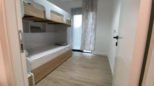 a small room with a closet with a bench in it at Modern Garden House in Tivat