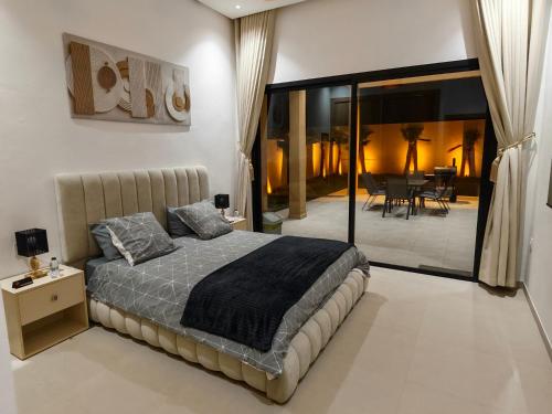 a bedroom with a bed and a dining room at Villa Inaya in Tasdert