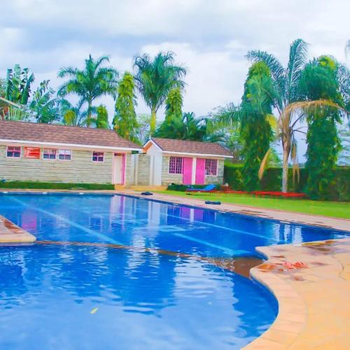 a swimming pool in front of a house at Destination Resort Centre in Gikuu