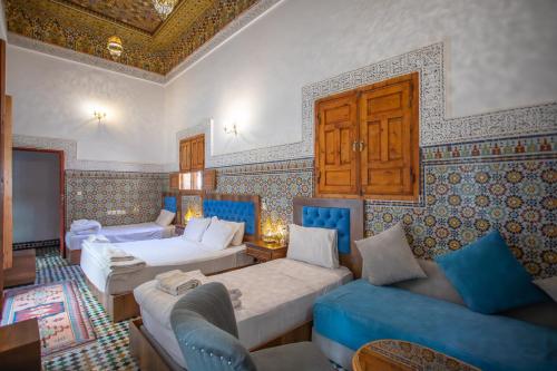 a living room with two beds and a couch at Dar Iline - RoofTop in Fez