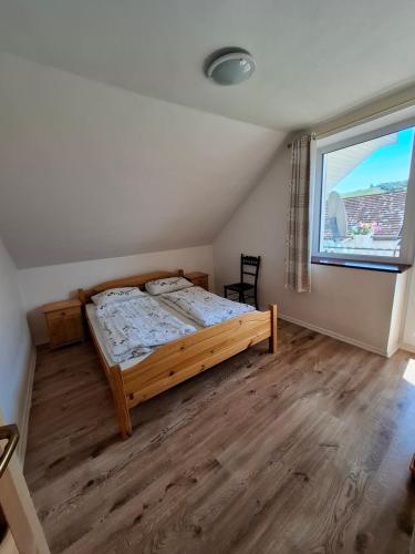 a bedroom with a bed and a large window at Chalupa u Strakov in Lúčky