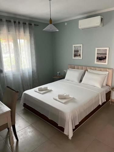 a bedroom with a large white bed with white pillows at Villa Harmony in Xanthi