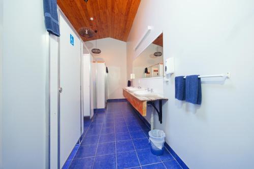 a bathroom with two sinks and two mirrors at Dusky Lodge in Kaikoura