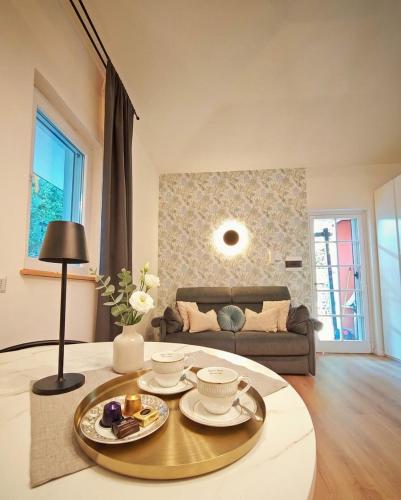 a living room with a table and a couch at Tiny Park House in Sabaudia