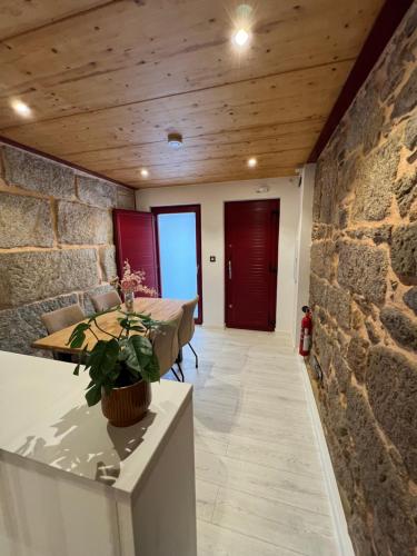 a room with a table and a stone wall at Mar De Pedra in Cangas de Morrazo